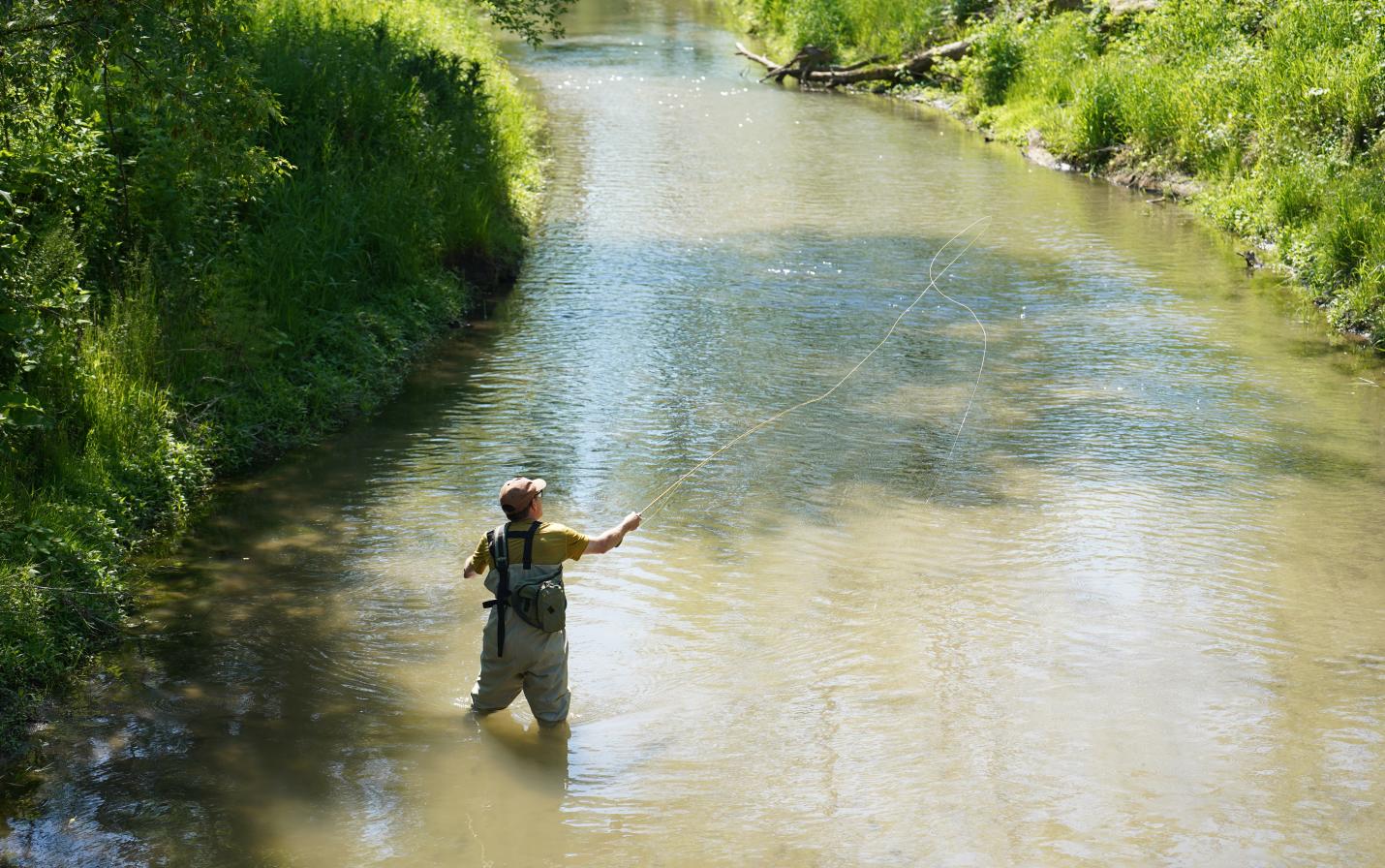 Photo by Samuel Li - An angler enjoys a quiet moment in Plum Creek fishing for trout.